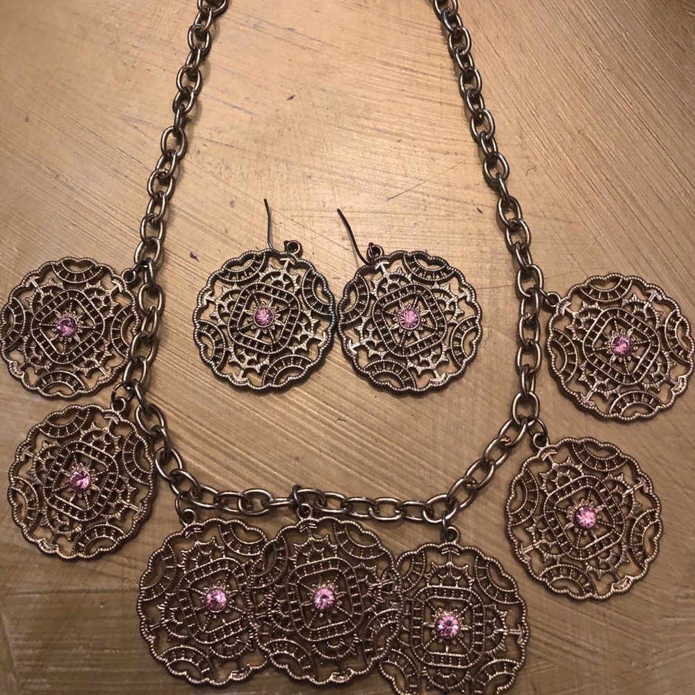 Necklace and Earrings with pink gem in the middle